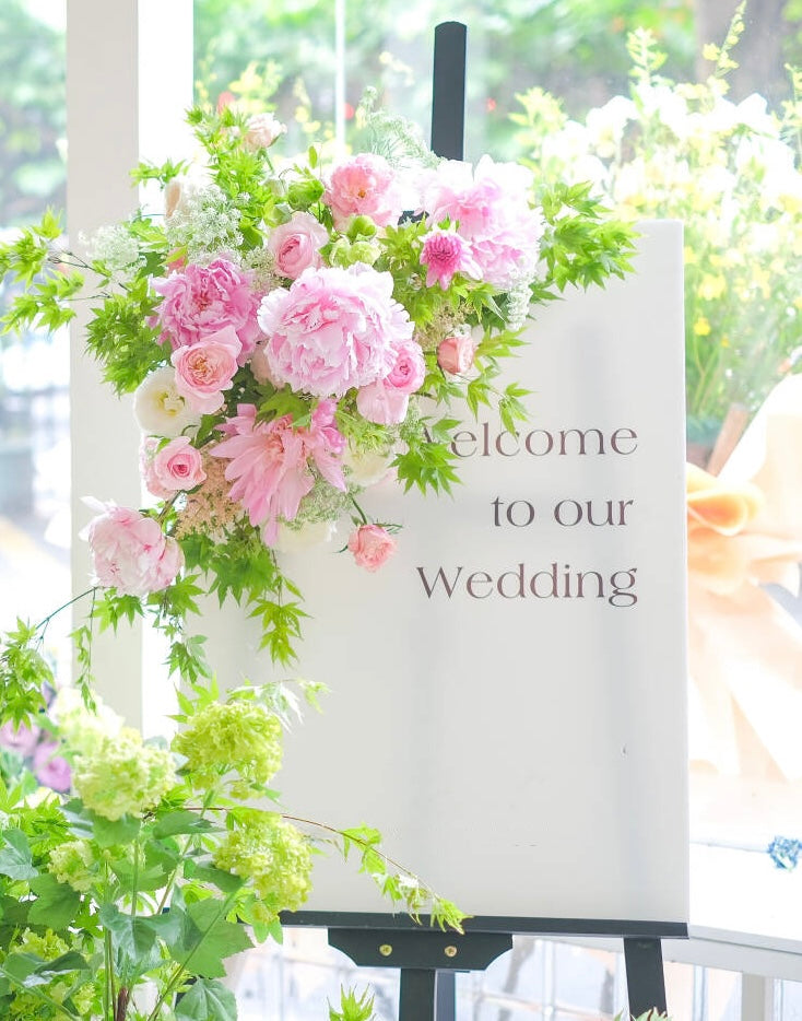 Pink garden-style wedding welcome sign florals with peonies and roses by Bay Area wedding florist