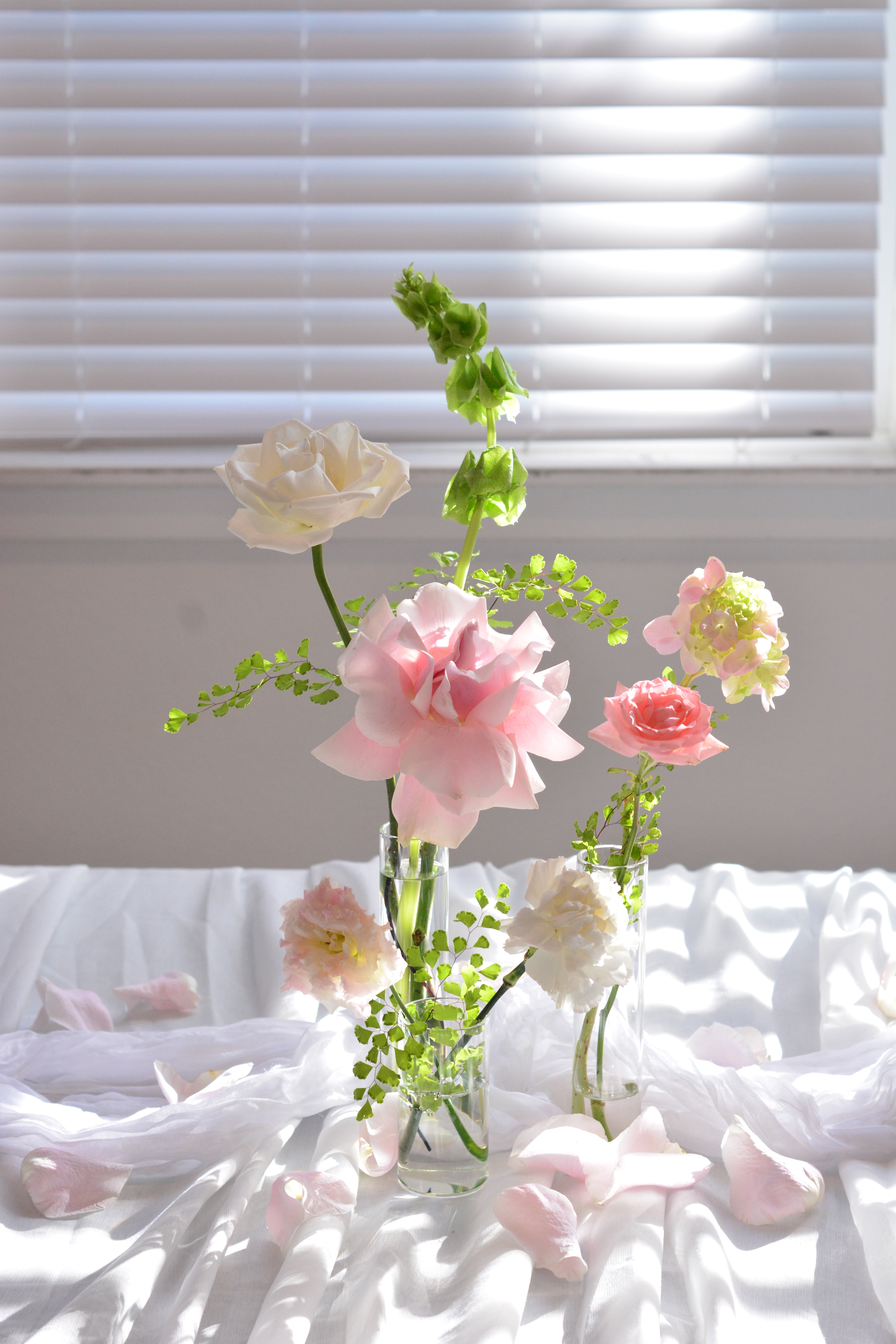 Garden-inspired bud vase arrangements for wedding reception tables