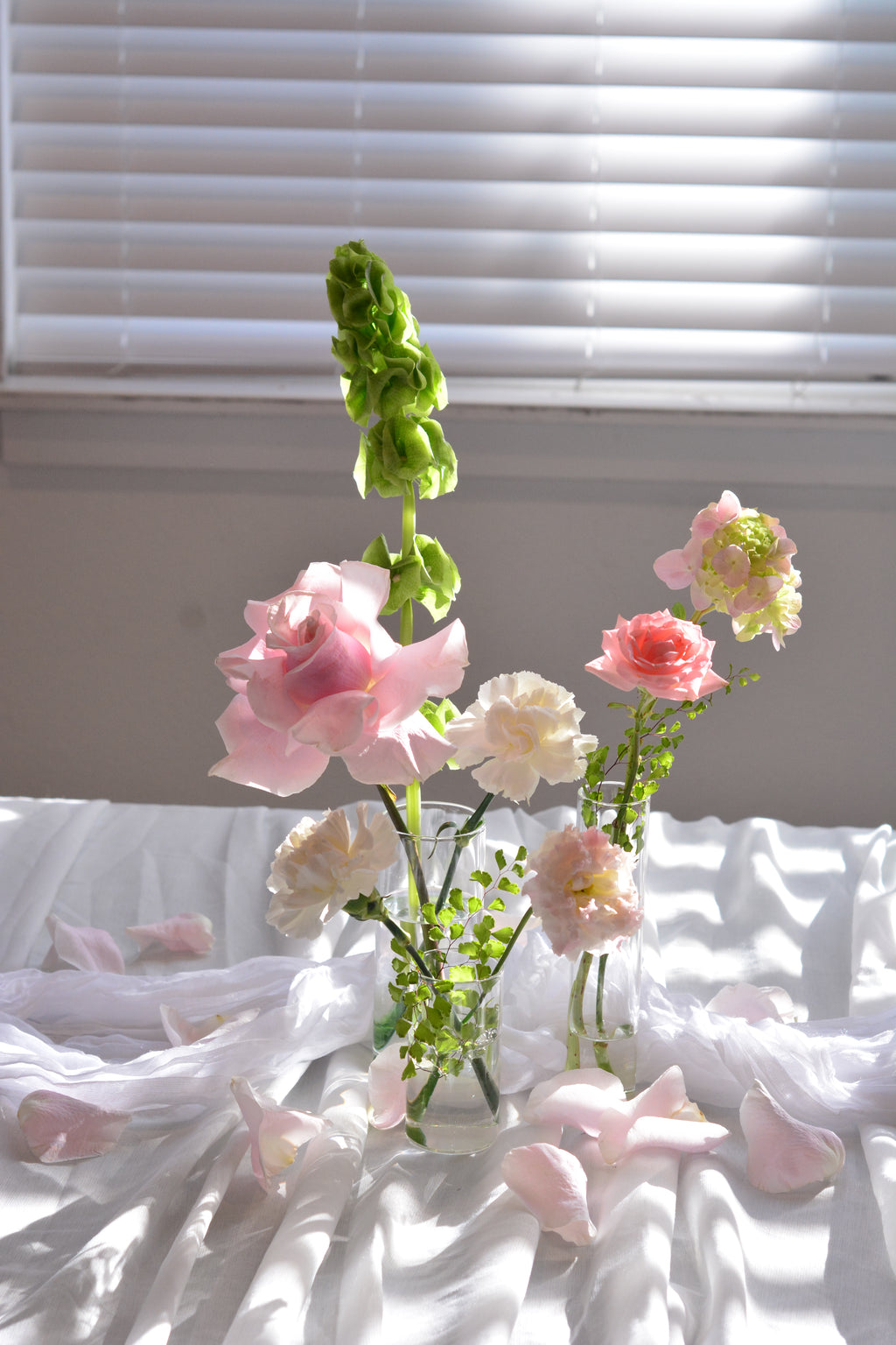 Garden-inspired blush wedding bud vases with premium seasonal flowers