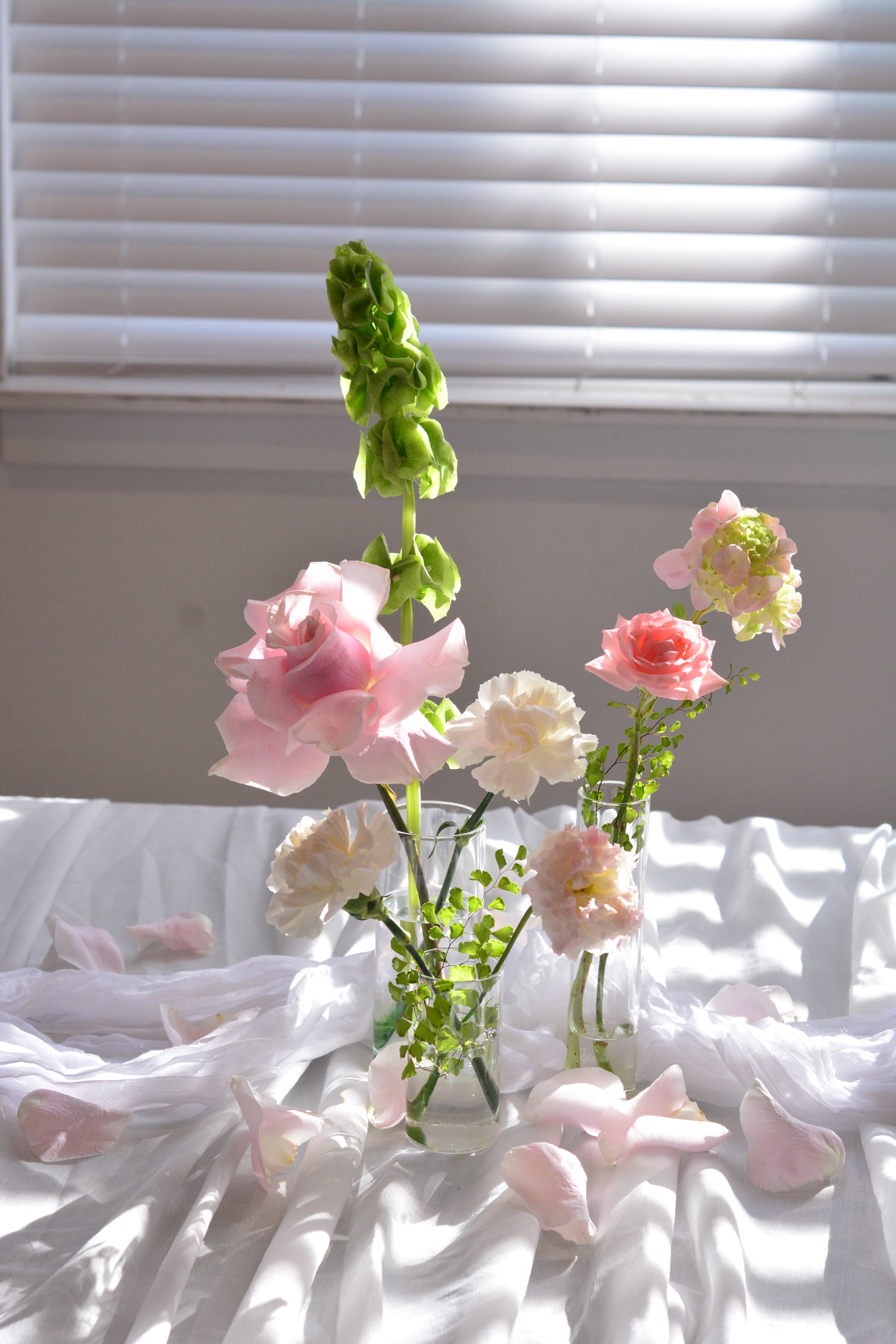 Garden-inspired blush wedding bud vases with premium seasonal flowers