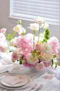Garden-inspired wedding centerpieces with blush pink and white flowers on a romantic tablescape