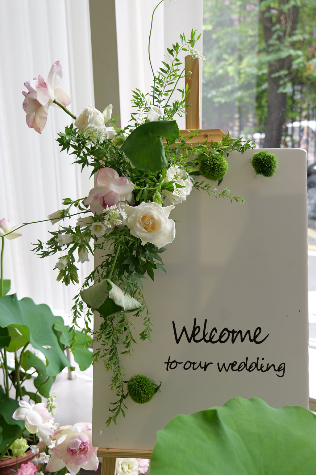Decorative floral arrangement with a Welcome sign.