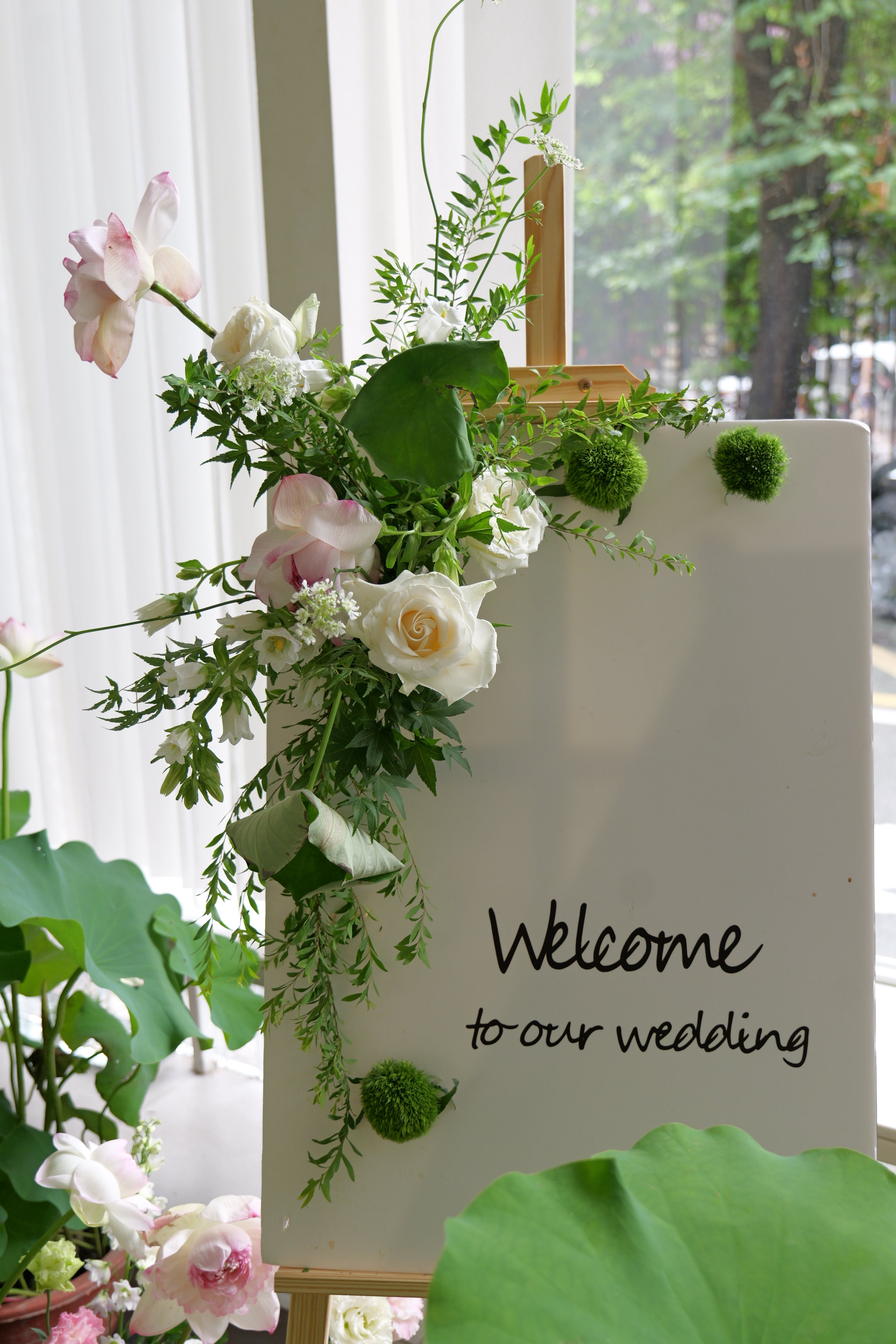 Decorative floral arrangement with a Welcome sign.