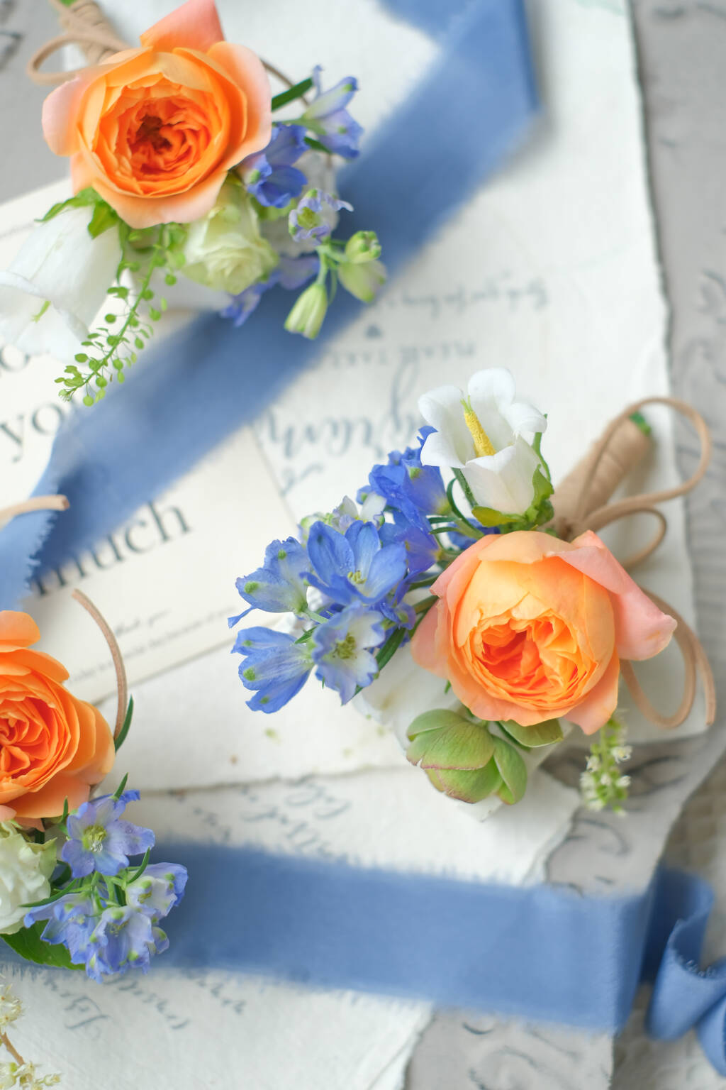 Orange garden rose and blue wedding boutonniere