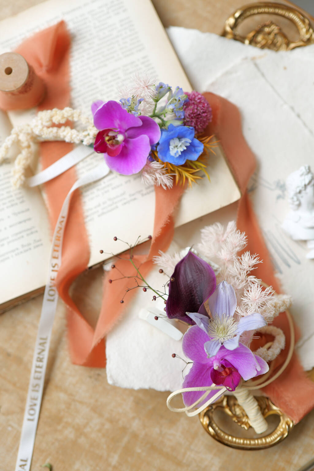 Orchid boutonniere with blue and purple calalilies
