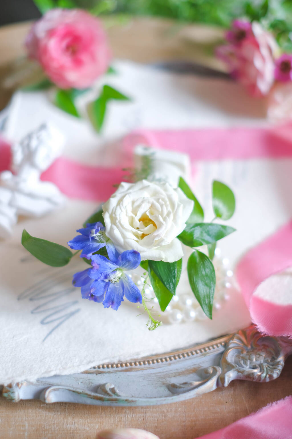 White rose wedding boutonniere with blue accents
