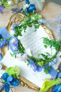 Blue and lavender floral crown with delphinium, calla lilies, and fresh greenery for weddings and special events