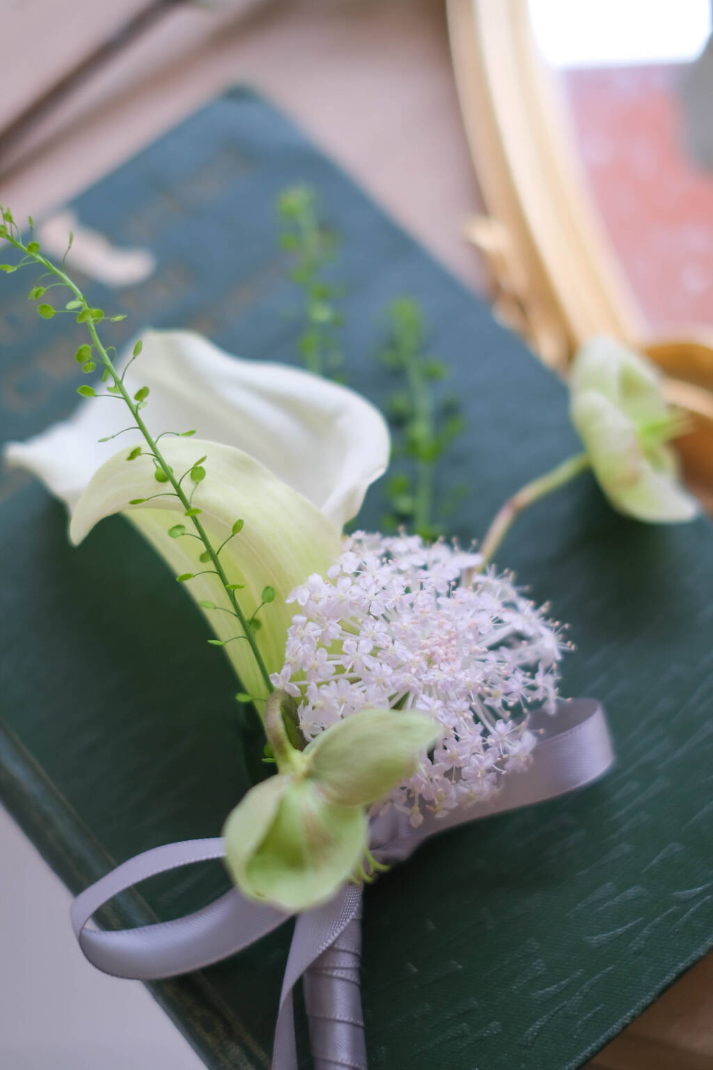 White calla lily wedding boutonniere with delicate flowers