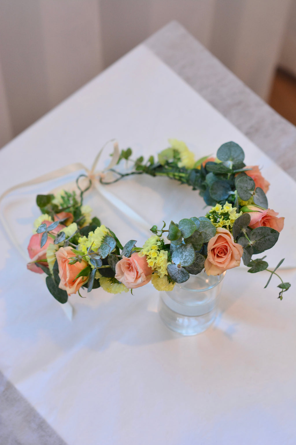 Garden style fresh flower crown with light orange spray roses and yellow blooms and greenery for weddings and special events. Bay area florist